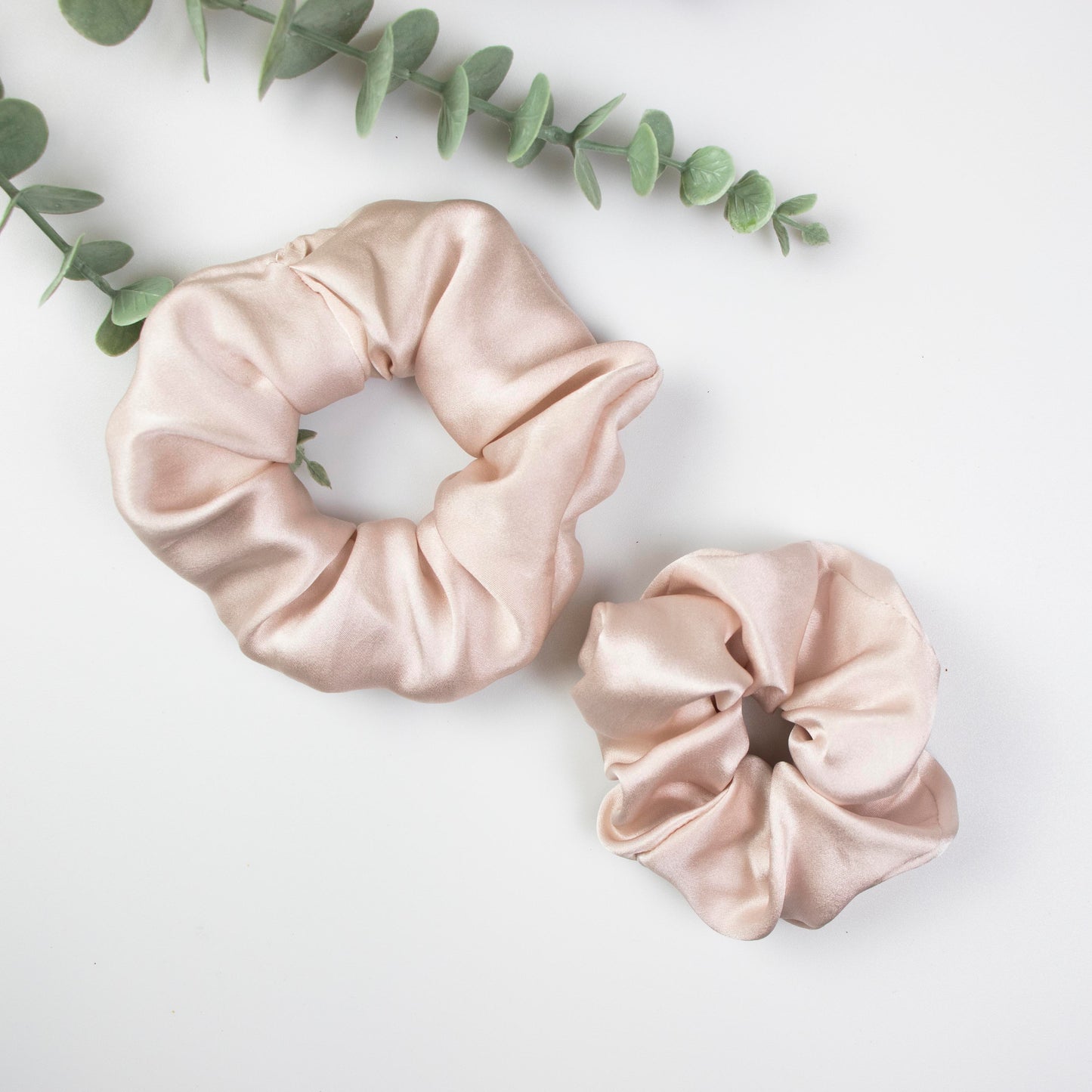 Peace Silk scrunchie blush rose – large and small size, eucalyptus sprig, overhead view